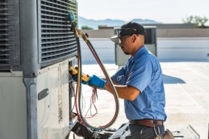 Mechanical HVAC services technician performing preventative maintenance on a commercial rooftop HVAC unit.